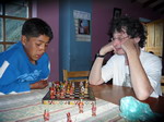 Victor playing chess with boy at orphanage